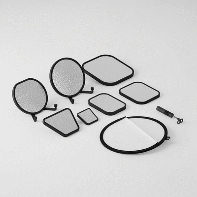 Close-up of various car photography lighting accessories like reflectors and diffusers